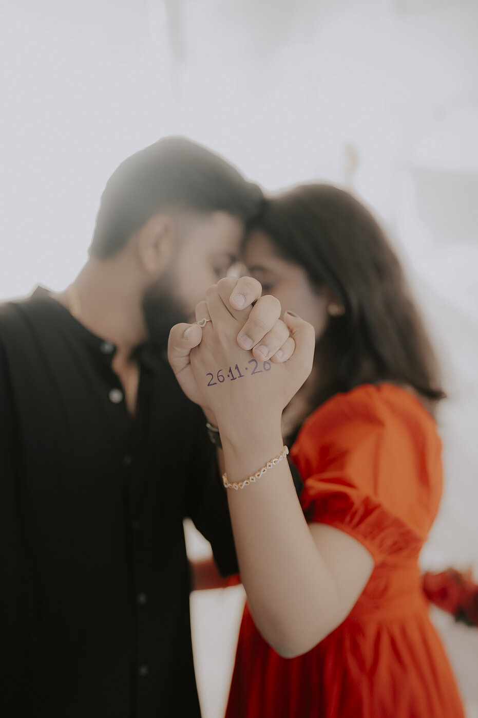 Navya and Subramanya showing their wedding date written on their hands
