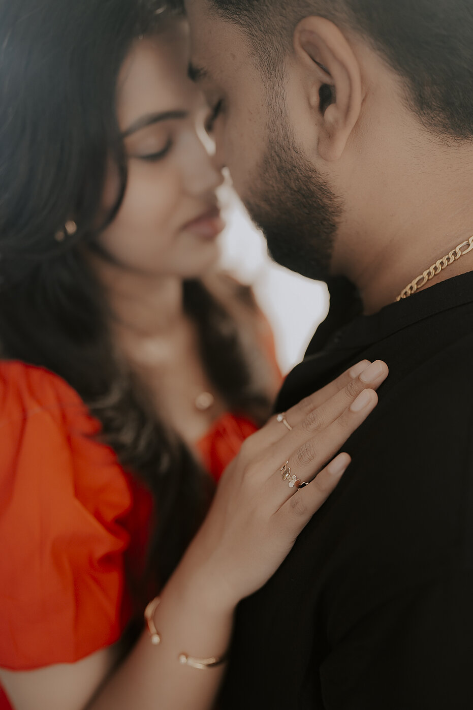Navya resting her hand on Subramanya's chest in a close embrace