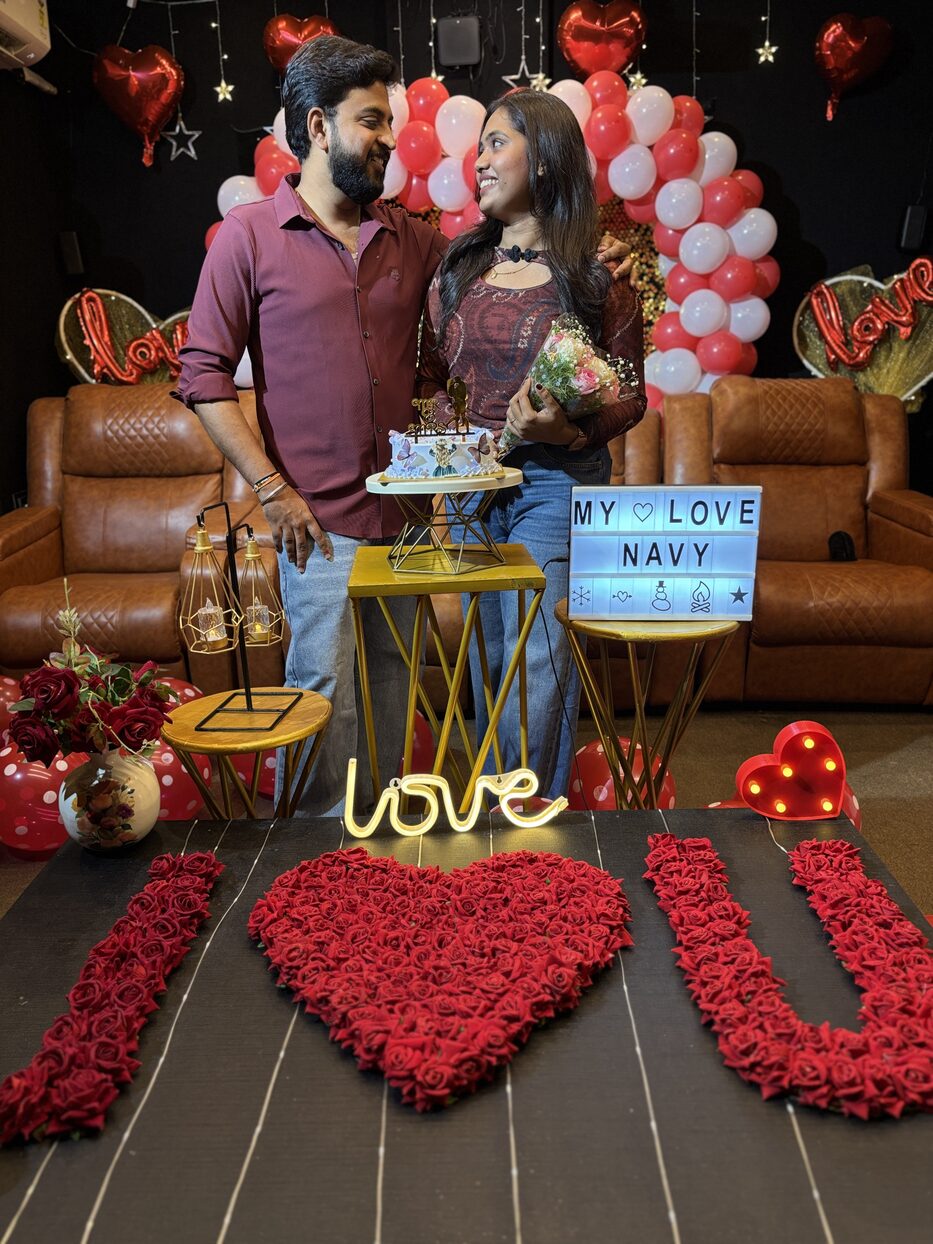 Navya holding a bouquet beside Subramanya at their proposal celebration